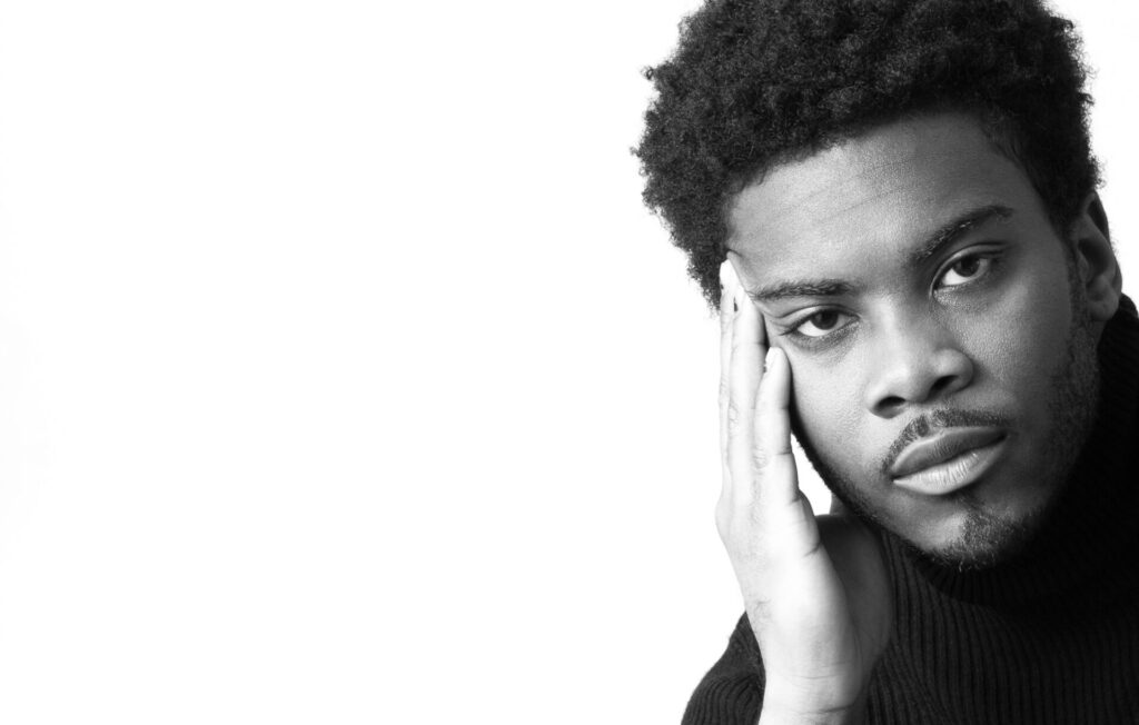 African American with a confident expression young man wearing a black knitted turtle neck