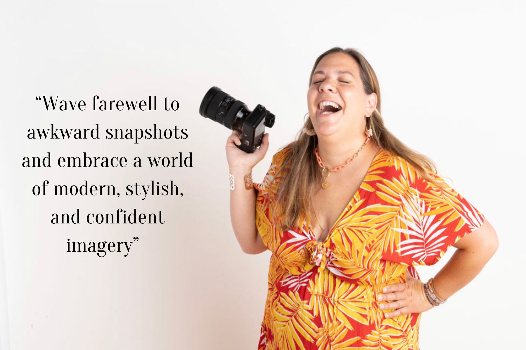 cute woman wearing a yellow and red hawaiian style dress laughing holding a camera