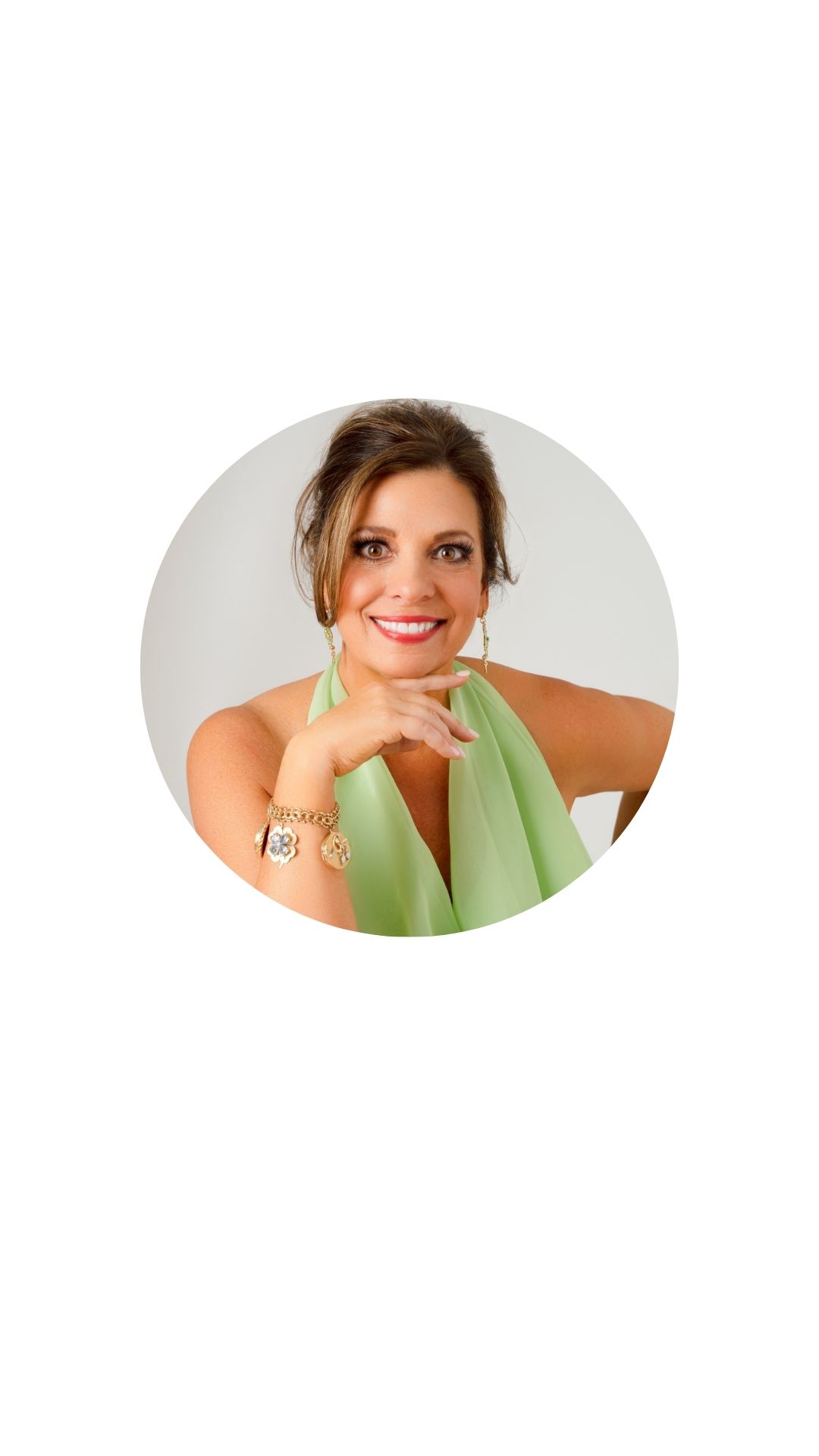 beautiful woman in her 50's with simple hair updo wearing a lime green halter top smiling brightly at the camera