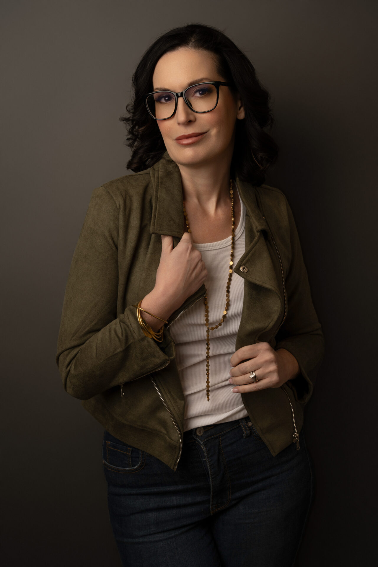 Professional headshot for a farmingdale-based entrepreneur in green jacket with confident expression, taken at The BeVard Studio