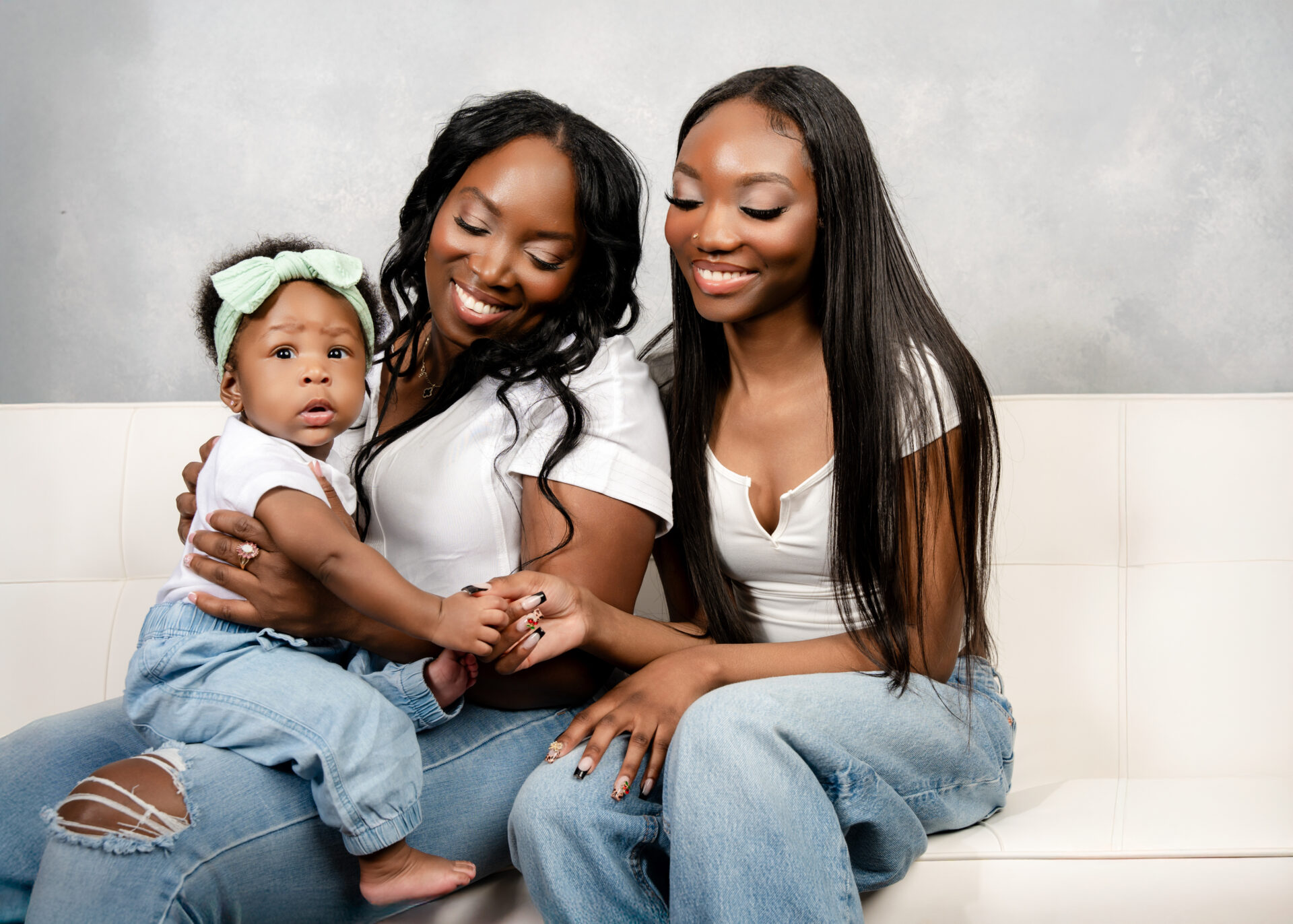 Two women and a child sitting together during a Long Island family photoshoot