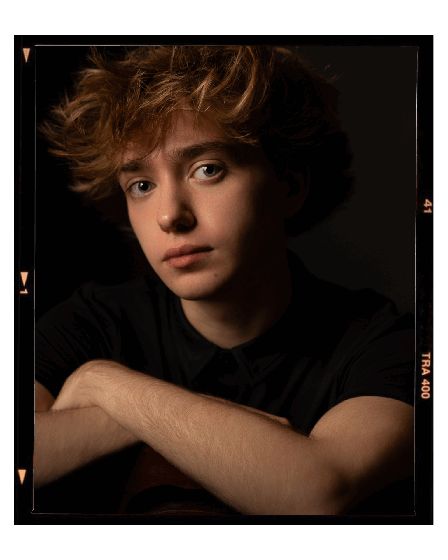 Dramatic portrait young man dark background