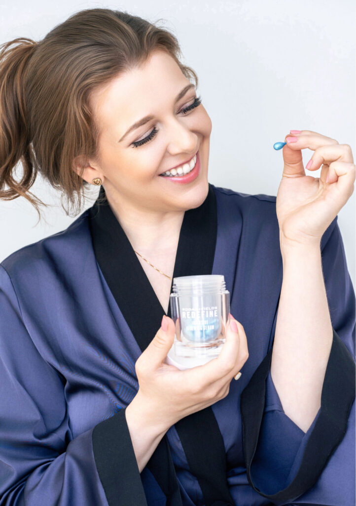 Personal branding photo of a Long Island skincare entrepreneur holding a Rodan + Fields serum capsule, captured by The BeVard Studio to highlight confidence and professionalism.