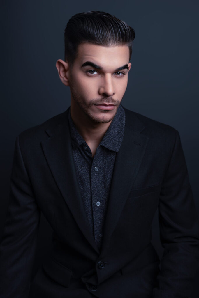 Professional corporate headshot of a male executive against a dark background in a Long Island studio
