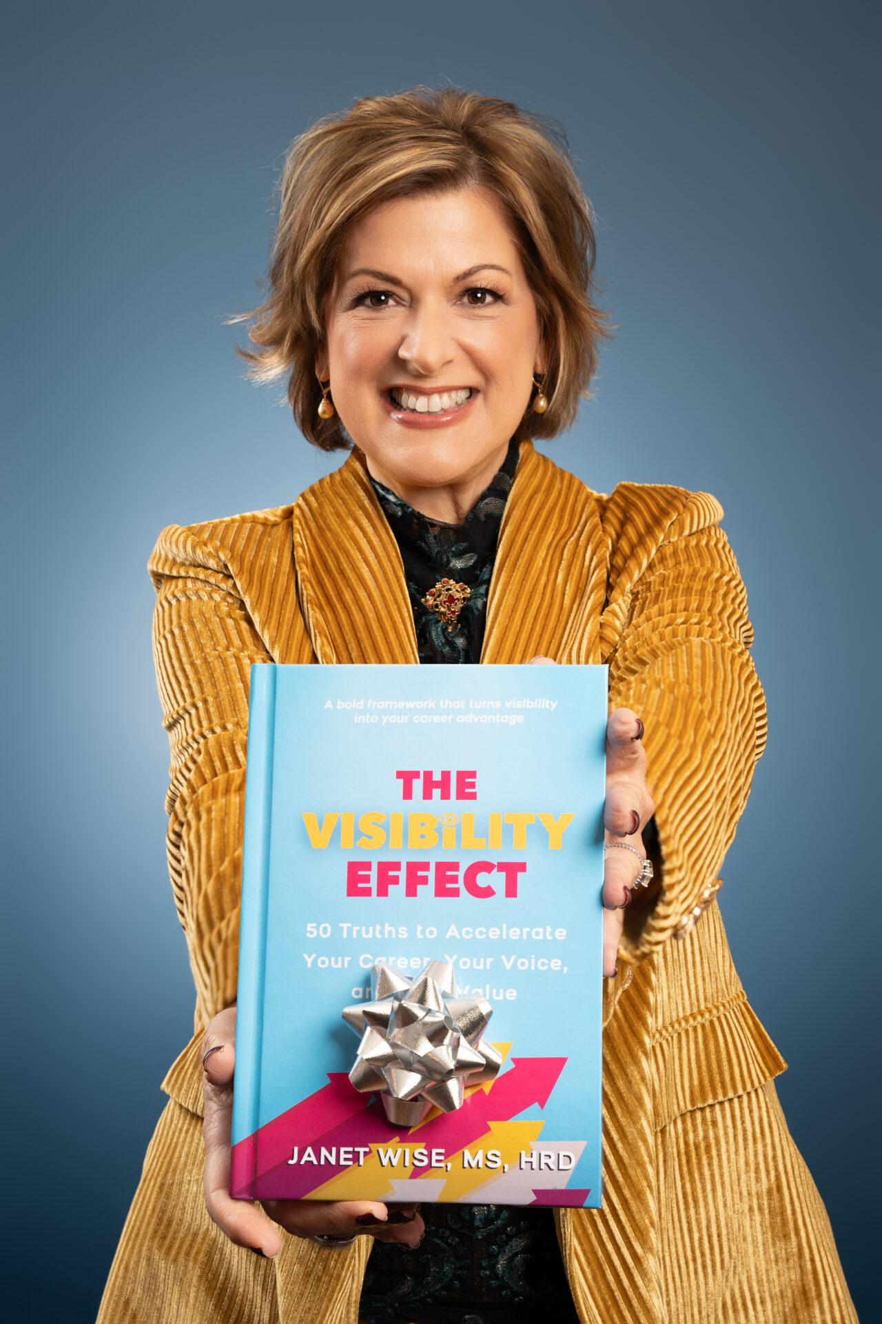 A confident female author posing in a white blazer for her personal branding photoshoot in Long Island