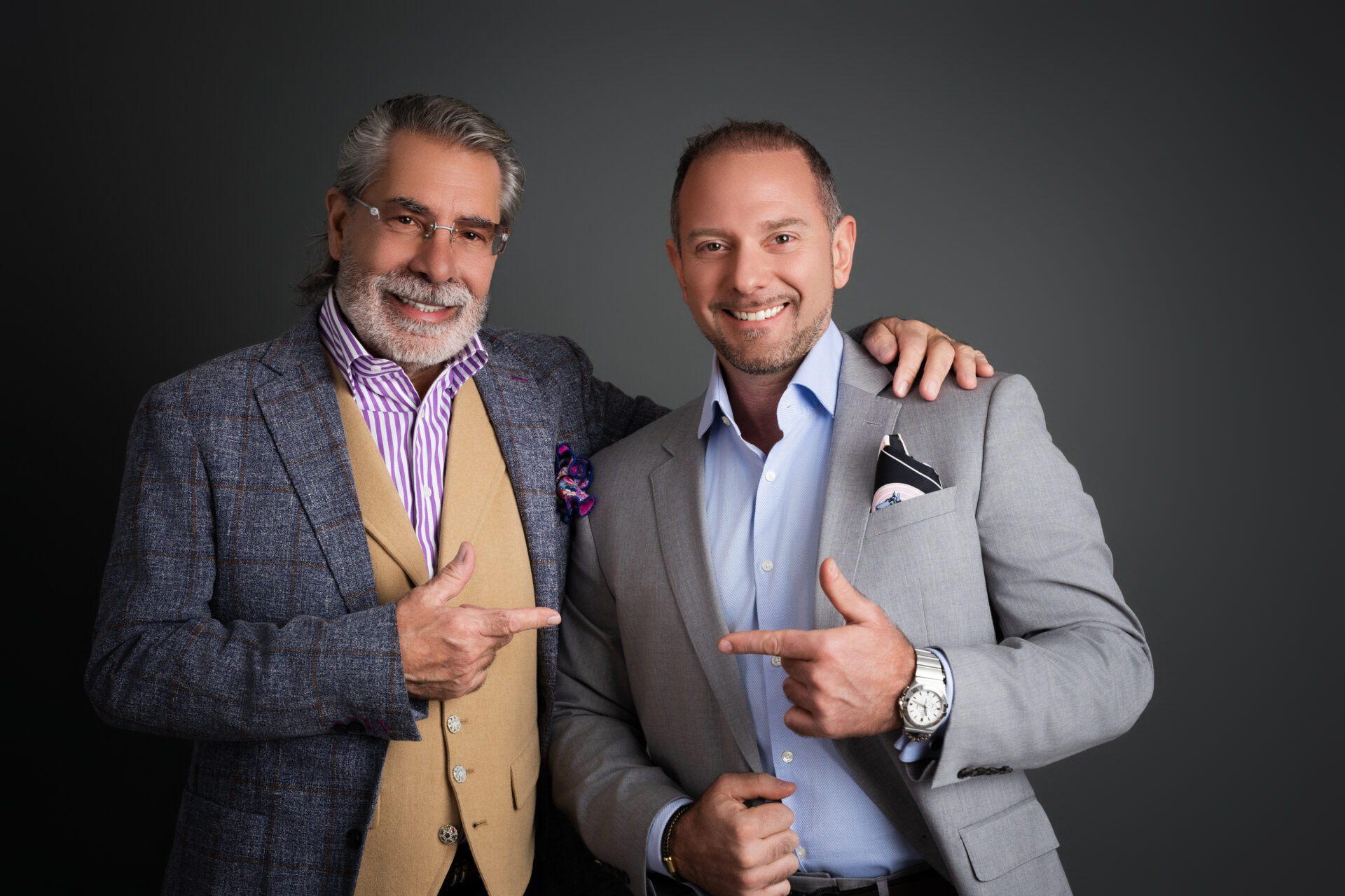 two male realtor partners smiling for their team photo in garden city new york