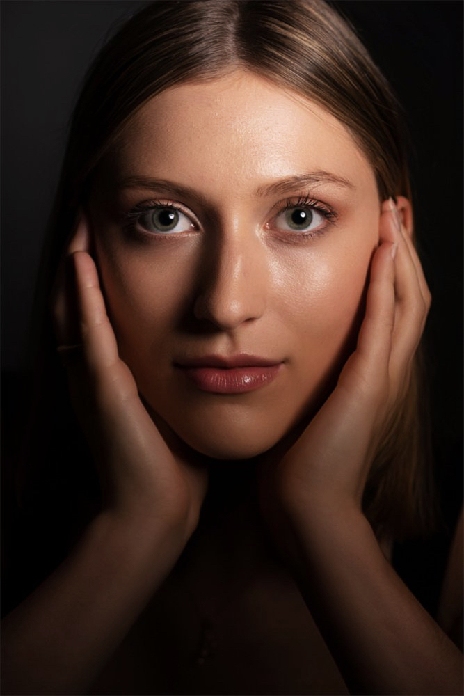 beautiful young woman looking fiercely at the camera with big blue eyes posing intentionally at a photo studio in Farmingdale new york 