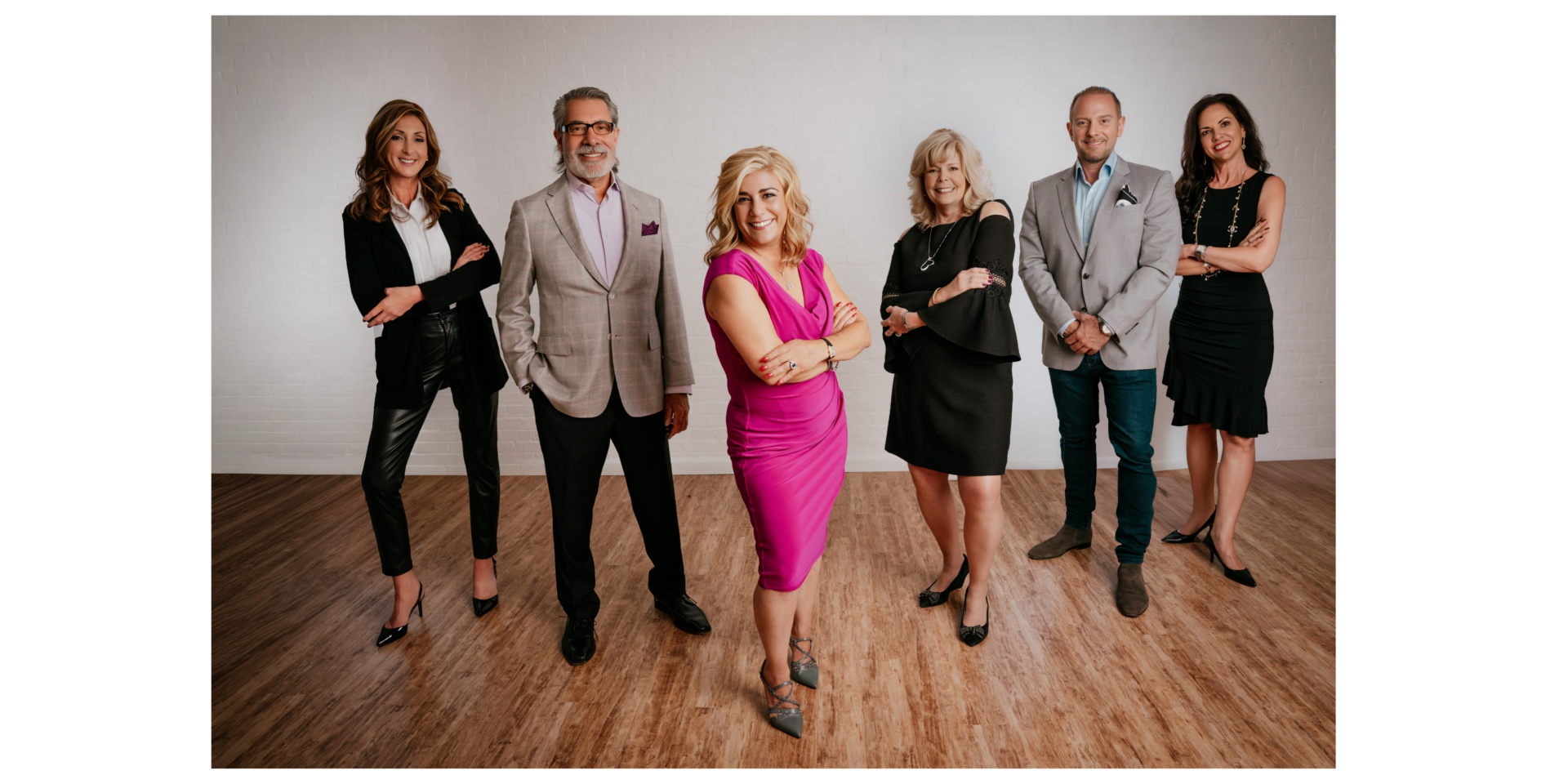 group of realtors smiling for a photo in a garden city new york studio