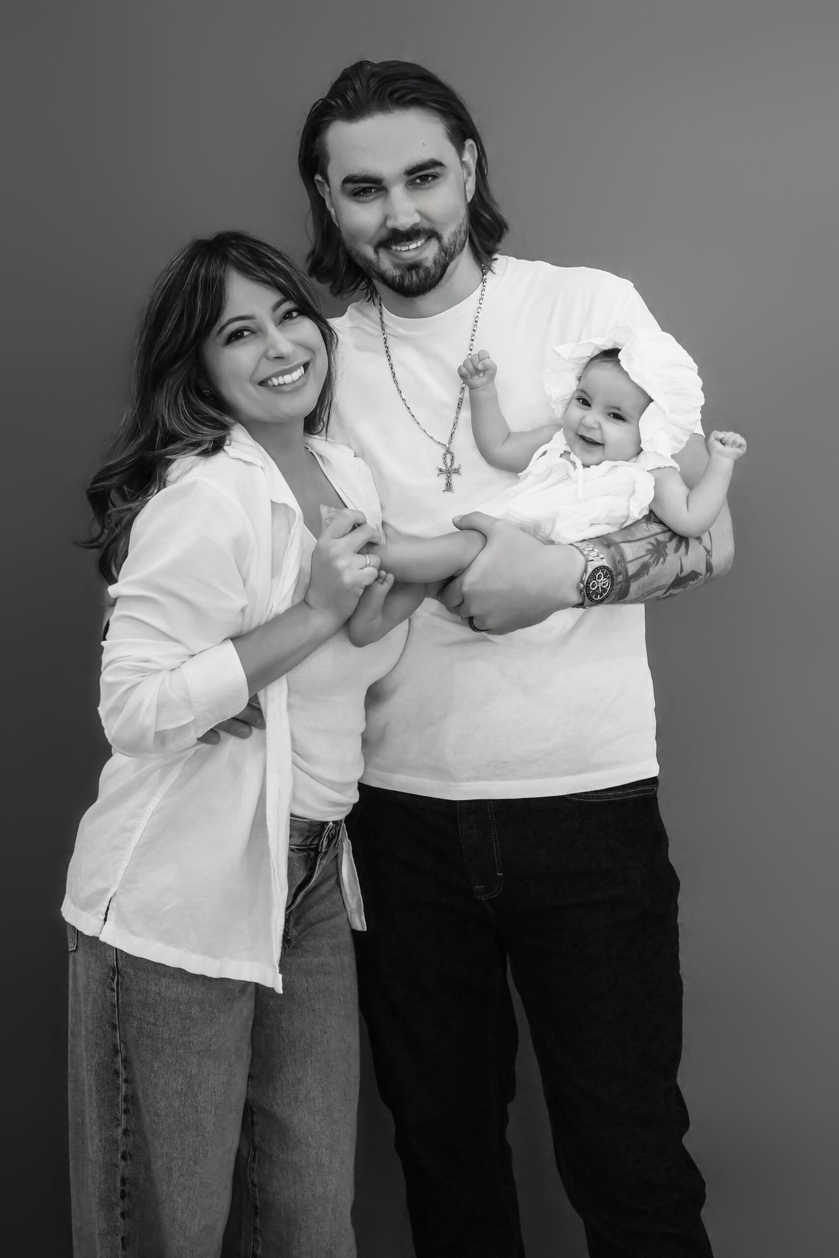 Black and white portrait of mom, dad and baby, family photographer Long Island