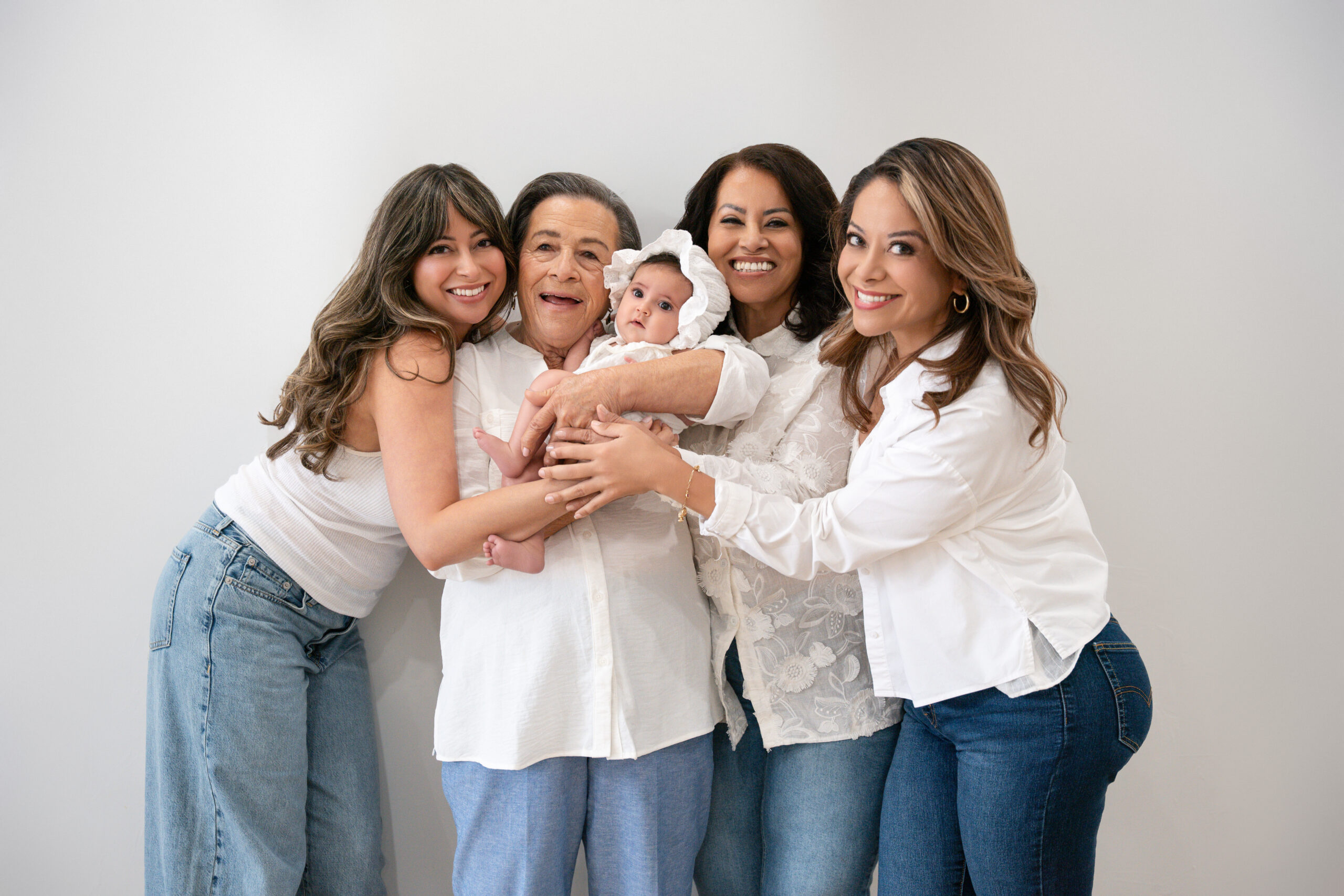 Five generations in white shirts and jeans hugging, family photoshoot Long Island