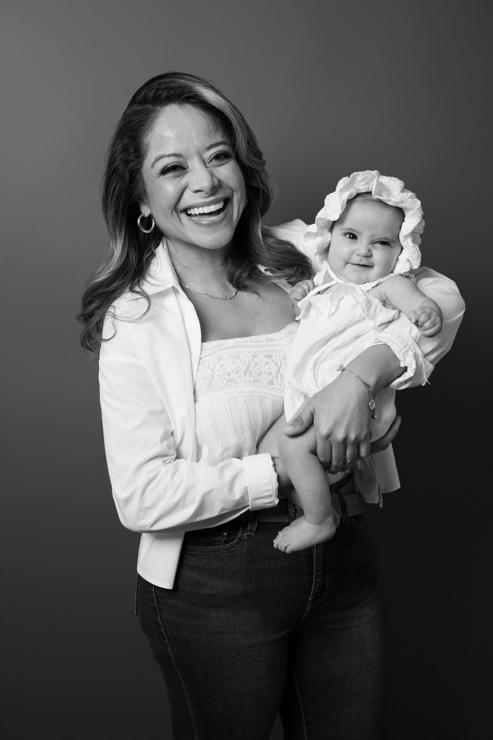 Black and white portrait of a mother laughing with her baby, Long Island family photographer